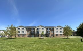 Somersworth apartment for rent - A large apartment complex with a grassy lawn in front.